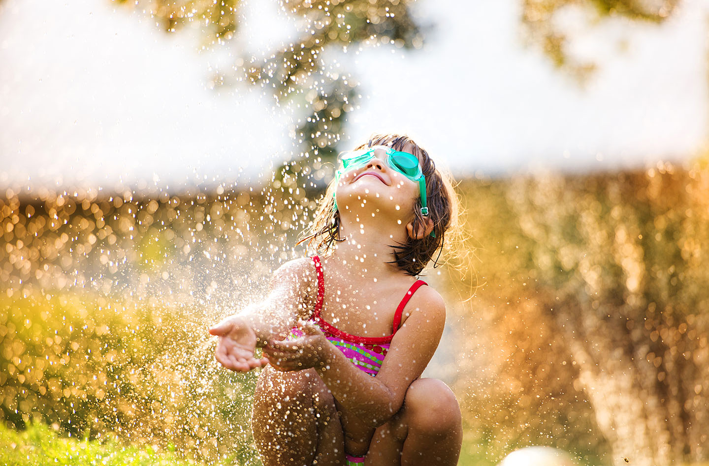 Cute little girl having fun outside in summer garden